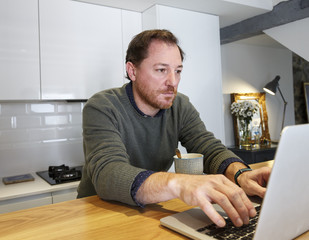 man working with laptop from home