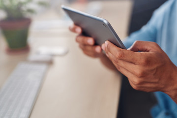Designer using a tablet at his desk in an office