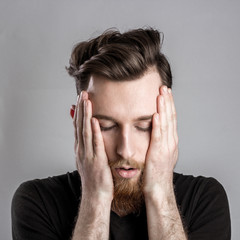 Tired sleepy young man isolated on gray background