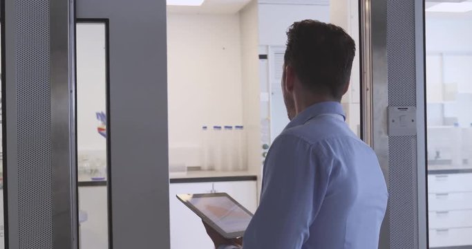 Pharmaceutical sales representative entering science laboratory