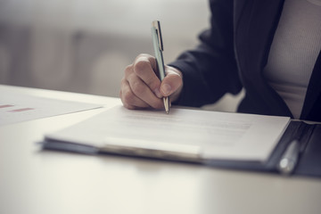 Businesswoman signing a contract or document
