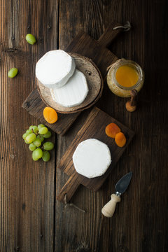 Soft camembert cheese with dried apricots and grapes