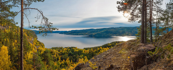 Obraz premium Panoramic view of norwegian fjord and autumn forests from above