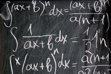Fototapeta na wymiar Abstract background of chalk written math formulas on black board