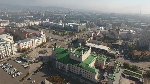 Unique flight above Ulan-Ude center square. High altitude drone footage 4k. Opera and ballet Theatre. Largest Lenin head. Soviet Russia architecture. Morning sun. Aerial 4k above the city