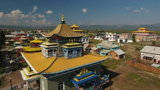 Ivolginsky Datsan Buddhist center important Monastery Russia Ulan-Ude Old complex temple. Yellow picturesque roof detail nature. Tourists walk  Summer sunny day. Drone drift close forward