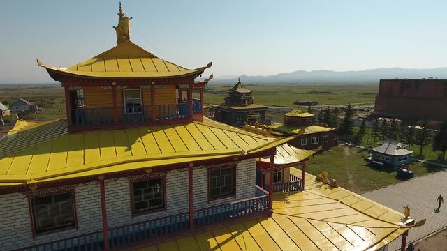 Ivolginsky Datsan Buddhist Monastery Russia Ulan-Ude Old complex temple. Yellow picturesque roof detail nature. Tourists walk  Summer sunny day. Drone drift close 