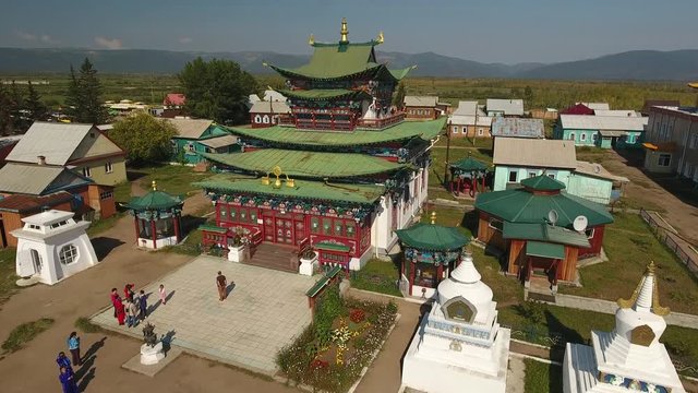 Ivolginsky Datsan Buddhist center Russia Ulan-Ude Old complex temple  Monument  Architecture. Suburgans Monks go out high mountains Picturesque cover Painting. Summer day. Drone aerial forward
