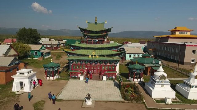 Ivolginsky Datsan Buddhist Monastery Russia Ulan-Ude. Old complex temple  Monument History Architecture. Suburgans Monks people. Picturesque cover carving. Summer day. Drone Approach close to 4k