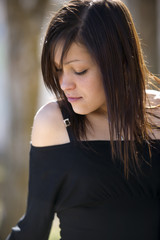 Portrait of young beautiful woman in field background