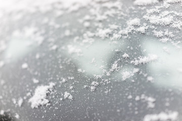 Snow covered patches on car window glass