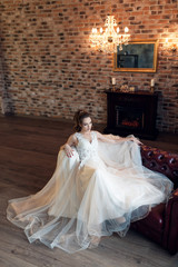 Bride in a luxurious apartment in a wedding dress.