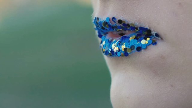 Close up creative make up of lips. Slow motion