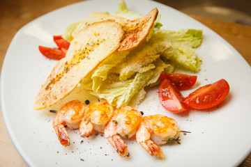 Delicious Caesar salad with shrimps