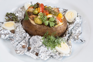 baked potatoes in foil with vegetables