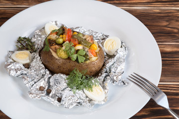 baked potatoes in foil with vegetables