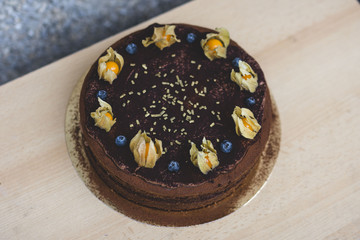 chocolate cake with cape gooseberries and blueberries