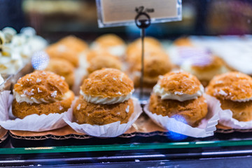 Whipped cream puffs on display in bakery
