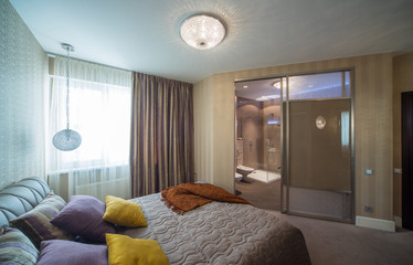 Bedroom, contemporary interior of home.  Integrated bathroom.