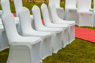 Many wedding chairs with white elegant covers