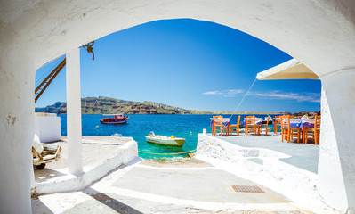 Obraz na płótnie Canvas The old harbor of Ammoudi under the famous village of Ia at Santorini, Greece.