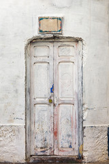 Old white wooden grungy door.