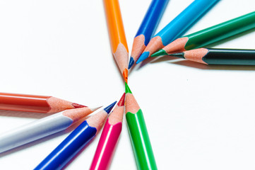 Naklejka premium Many different colored pencils on paper background.