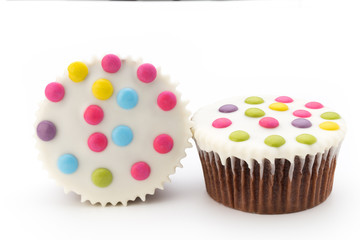 Multiple colorful decorated muffins on a white background.
