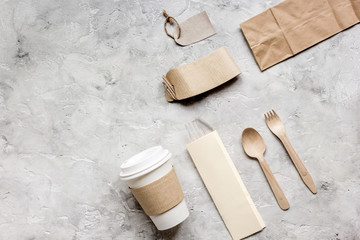 breakfast take away with paper bags on gray table background top view mock up