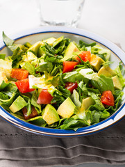 Healthy avocado spinach tomato salad. Gourmet dieting