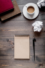 writer workplace with tools on wooden background top view