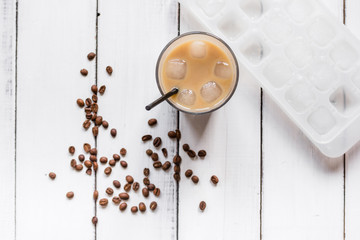 Ice coffee with milk for lunch on white wooden background top view