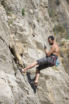Young man climbing. Rock climber.