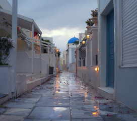 Evening view of the promenade in Oia village after the rain