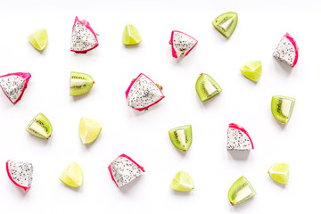 pattern with sliced kiwi and pitaya on white background top view