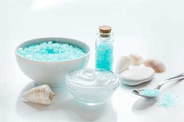 Fototapeta na wymiar sea salt and body cream on white desk background