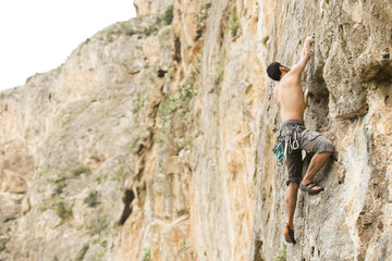 Young man climbing on a wall