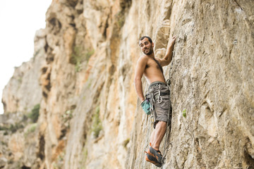 Young man climbing on a wall