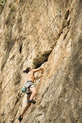 Young man climbing on a wall