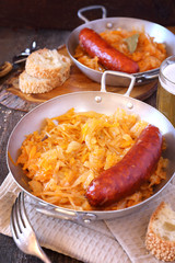 Homemade braised sauerkraut with smoked sausages, beer and bread