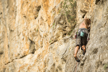 Young man climbing on a wall