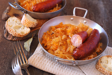 Homemade braised sauerkraut with smoked sausages and bread