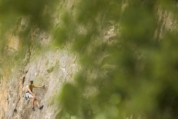 Young man climbing on a wall
