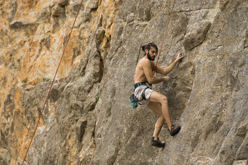 Young man climbing on a wall
