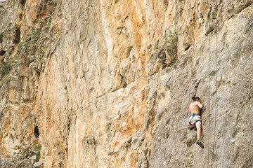Young man climbing on a wall