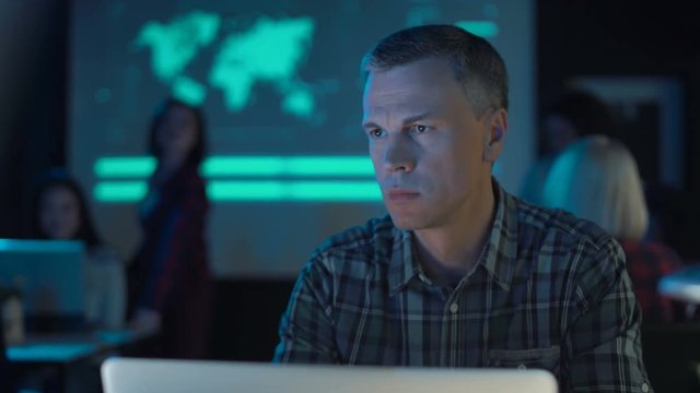 Adult successful man talking smartphone in futuristic office.