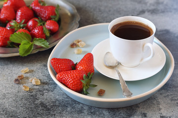 Red strawberries  and cup of black coffee