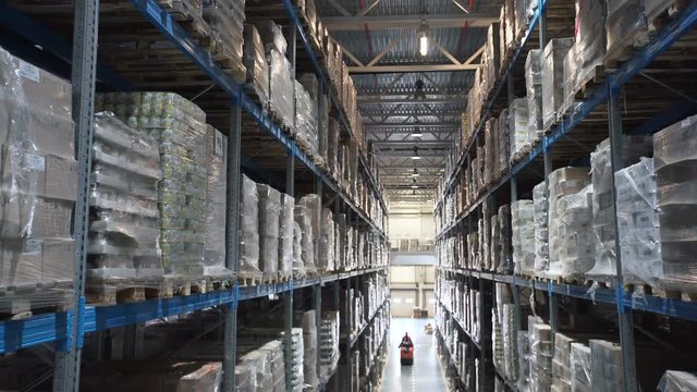 big factory warehouse. store Aisles. Camera travels inside a large store. Warehouse shipping. Logistics business and shipping facility with forklift to move boxes and goods