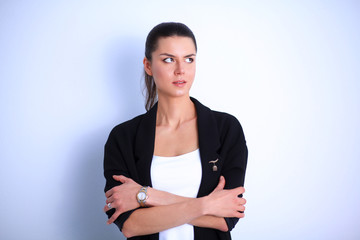 Young woman standing, isolated on gray background