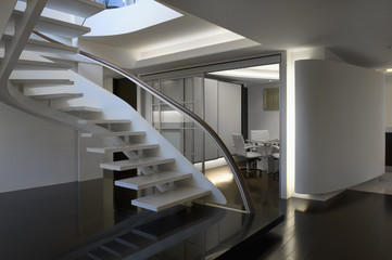 Modern white staircase with glass banister